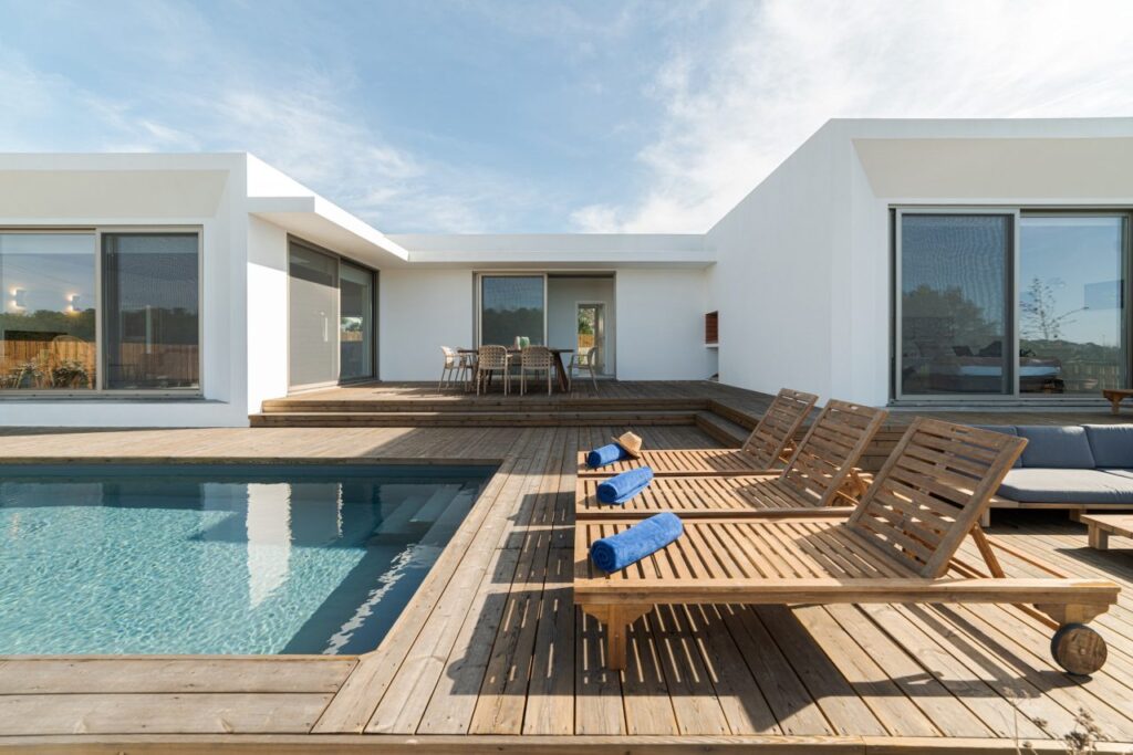 lounge chairs in modern villa pool - Rental News - Ayokunle Homes Are you keen on maximizing the returns on your property investment? Look no further than the burgeoning short-let apartment business